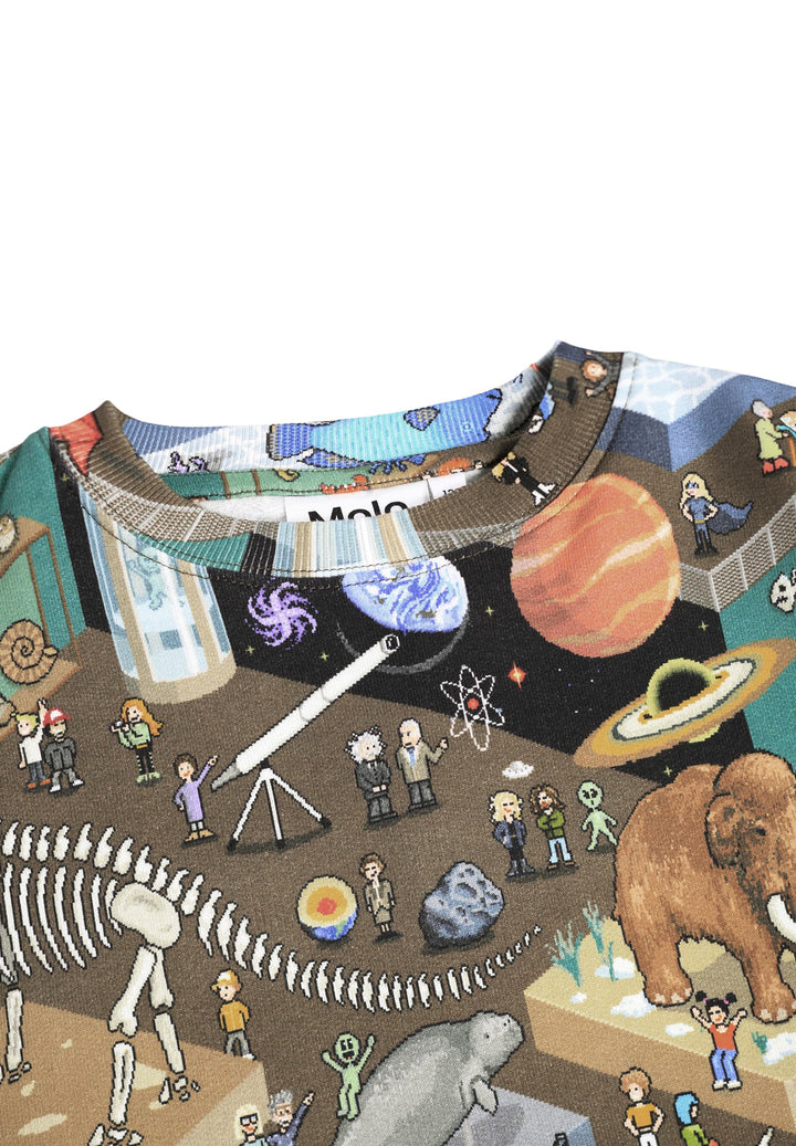 close up on the pattern Children's shirt with a colorful design of animals, planets, and people in a museum setting.