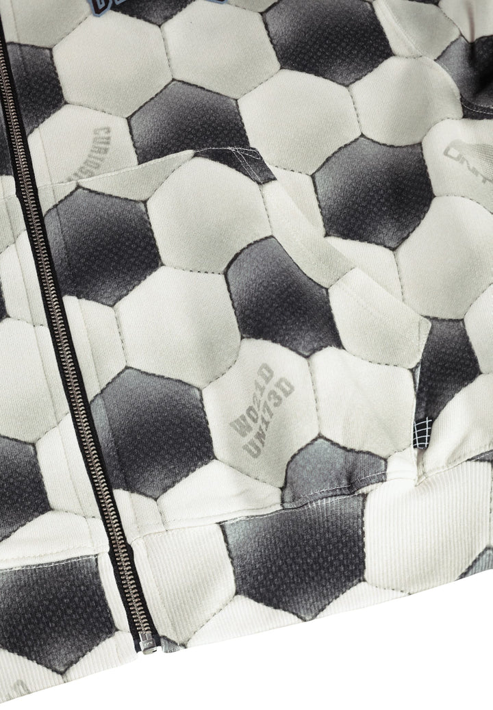 Close-up of a patterned fabric with hexagonal shapes and 'Made in Italy' branding.