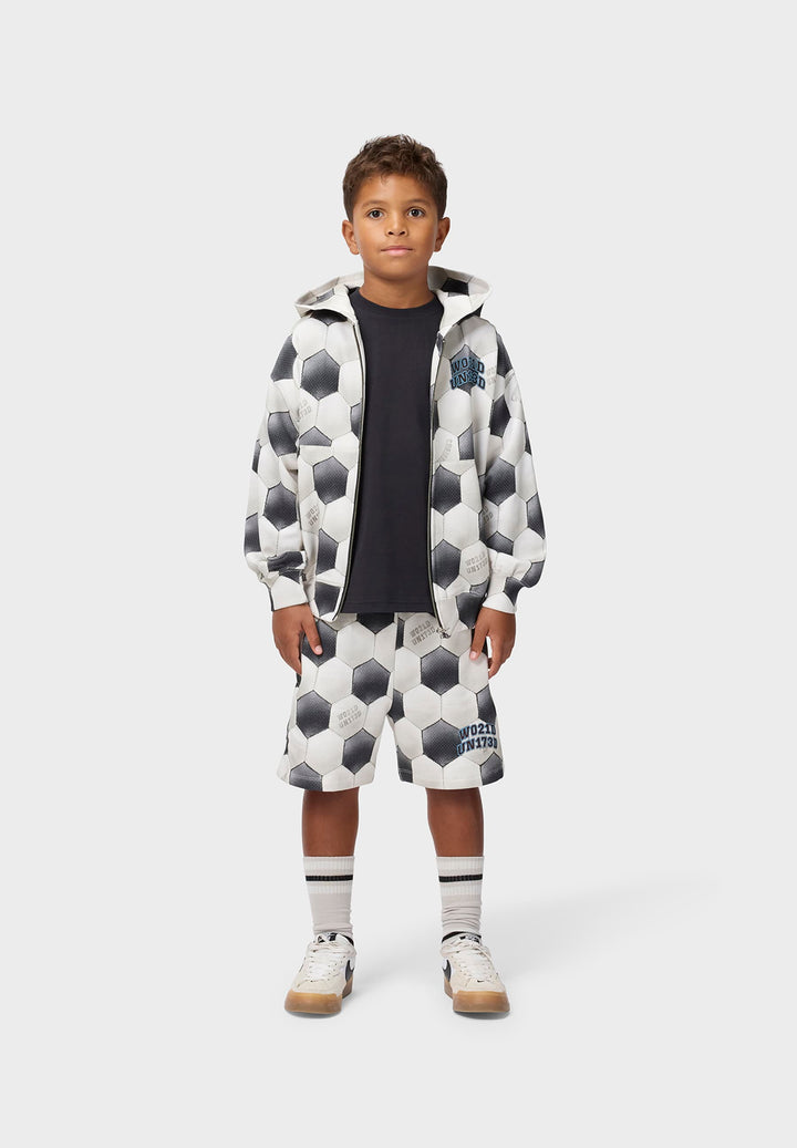 Child wearing a patterned outfit on a white background