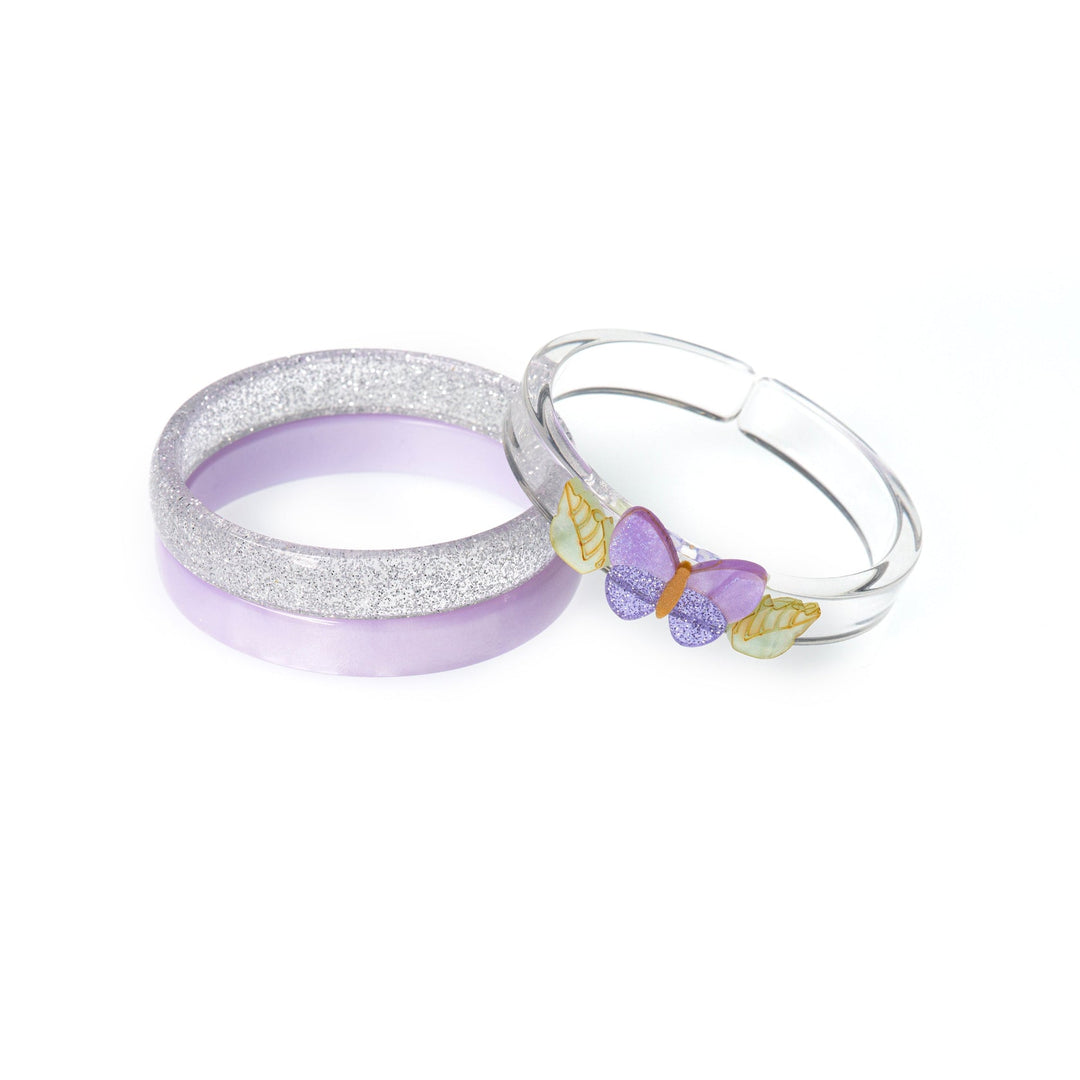 Three bangles with one featuring a butterfly design on a white background