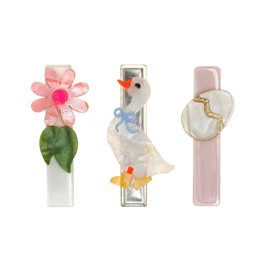 Three decorative hair clips with floral, duck, and butterfly designs on a white background.