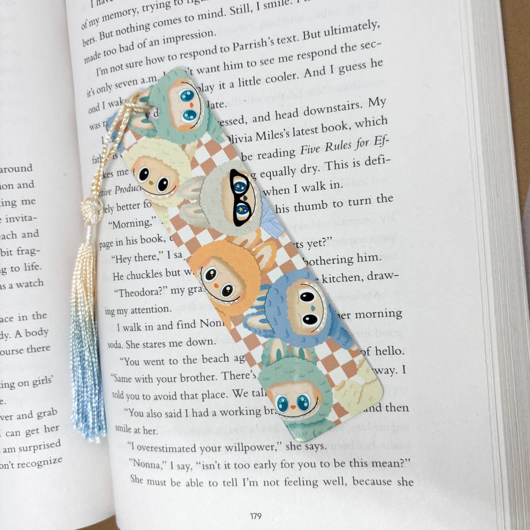 Bookmark with cartoon labubu characters on a book