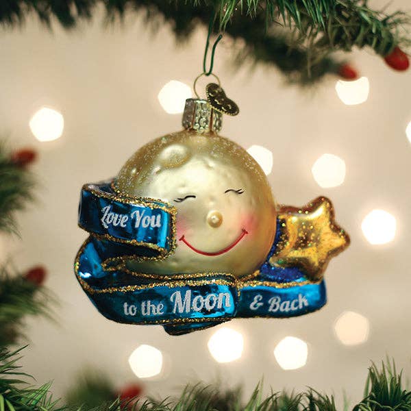 Decorative Christmas ornament with a moon and star design, hanging on a tree.