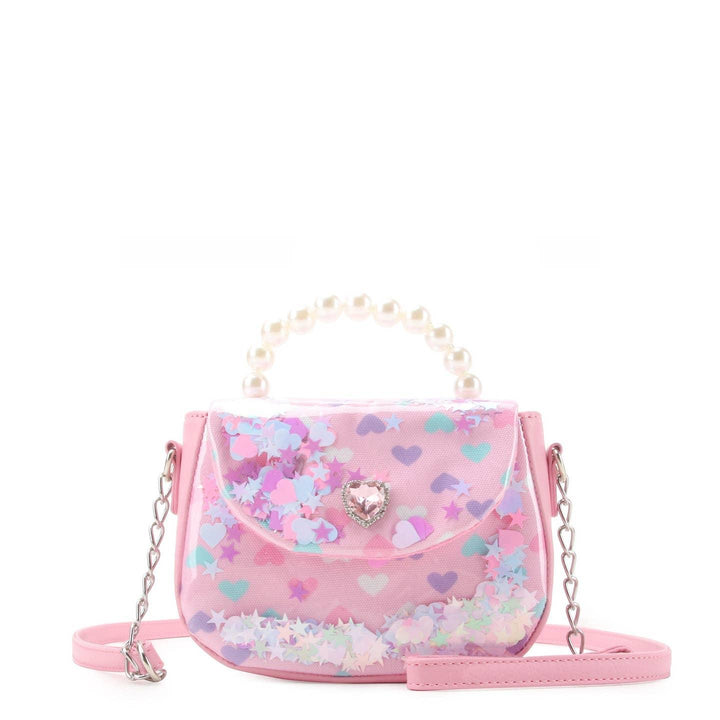pink crossbody bag with flap and pearl handle and glitter confetti on the inside on the bag