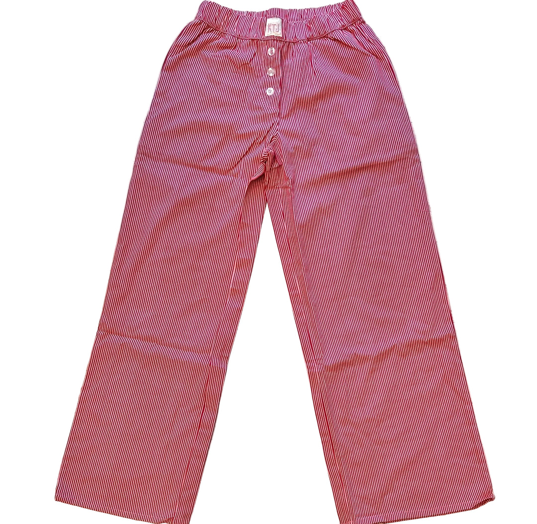 Red small gingham check pants on a wooden surface