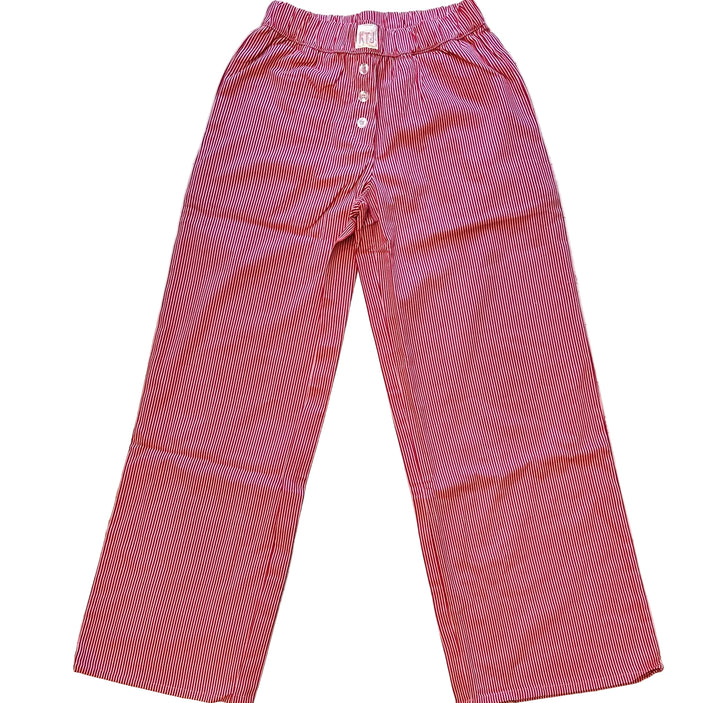 Red small gingham check pants on a wooden surface
