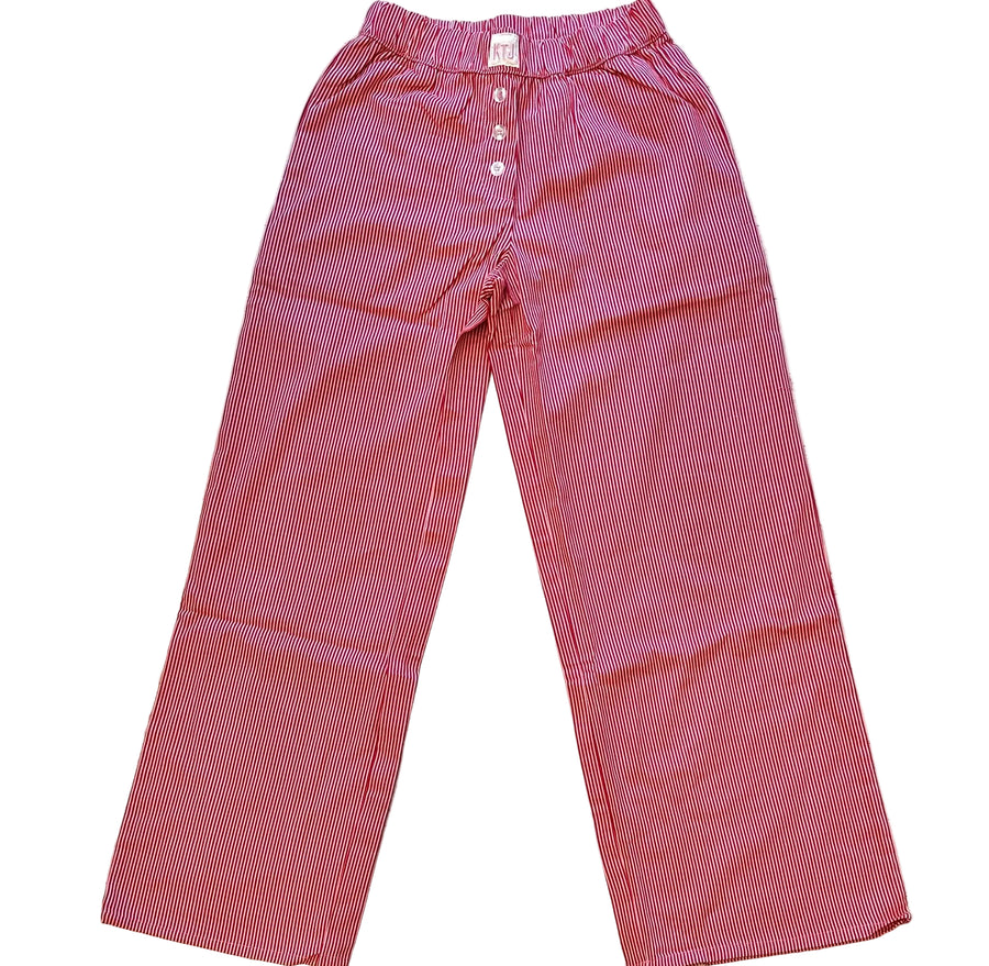 Red small gingham check pants on a wooden surface