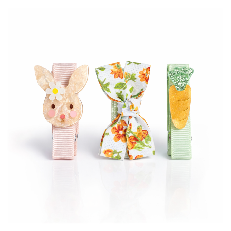 Three decorative hair clips with bunny, floral, and carrot designs on a white background.