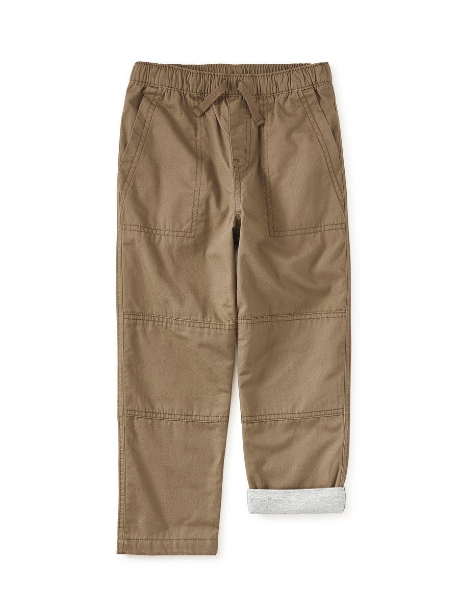 Tan pants with multiple pockets and the interior of the pants lined with jersey cotton 