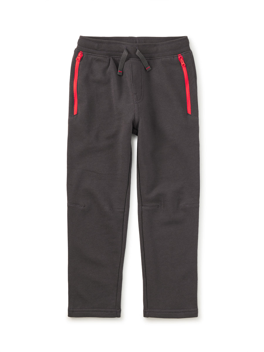 Dark gray sweatpants with red zippers on a white background