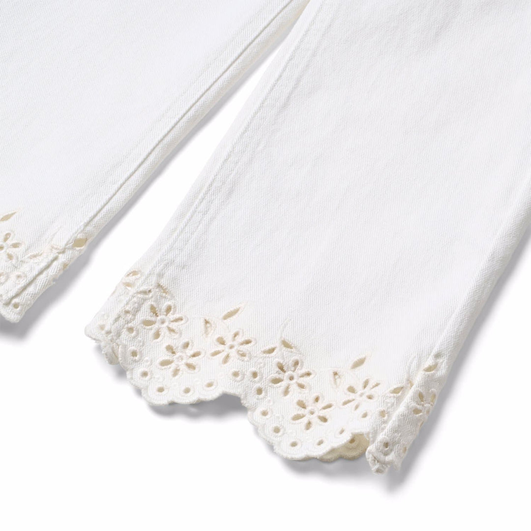 White doily with lace edge on a white background