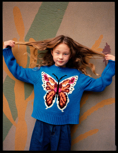 Girl wearing Gulda Butterfly Knit Blue Sweater from Molo