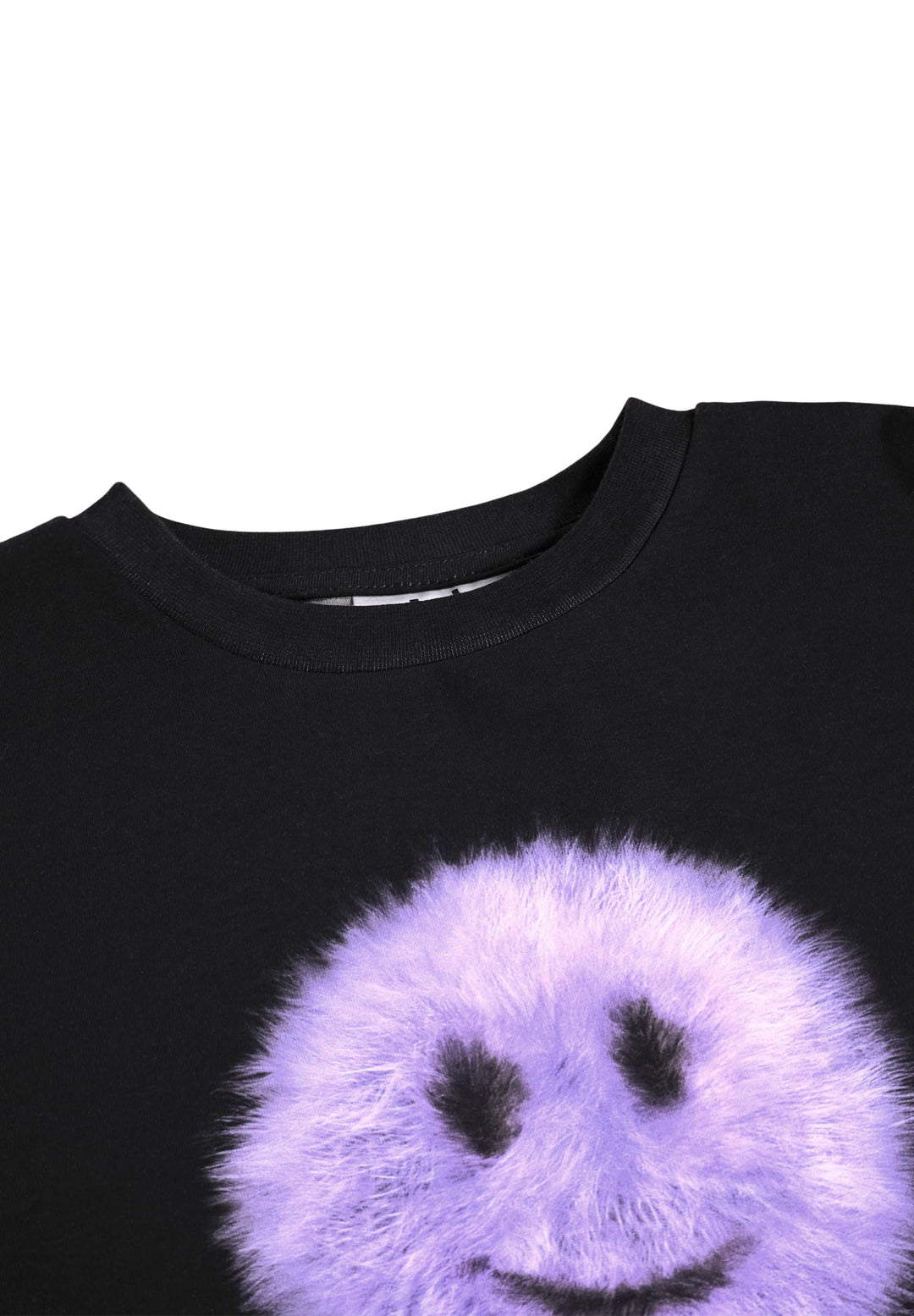 Close-up of a black crewneck shirt featuring a large, fuzzy lavender-purple smiley face graphic on the front.