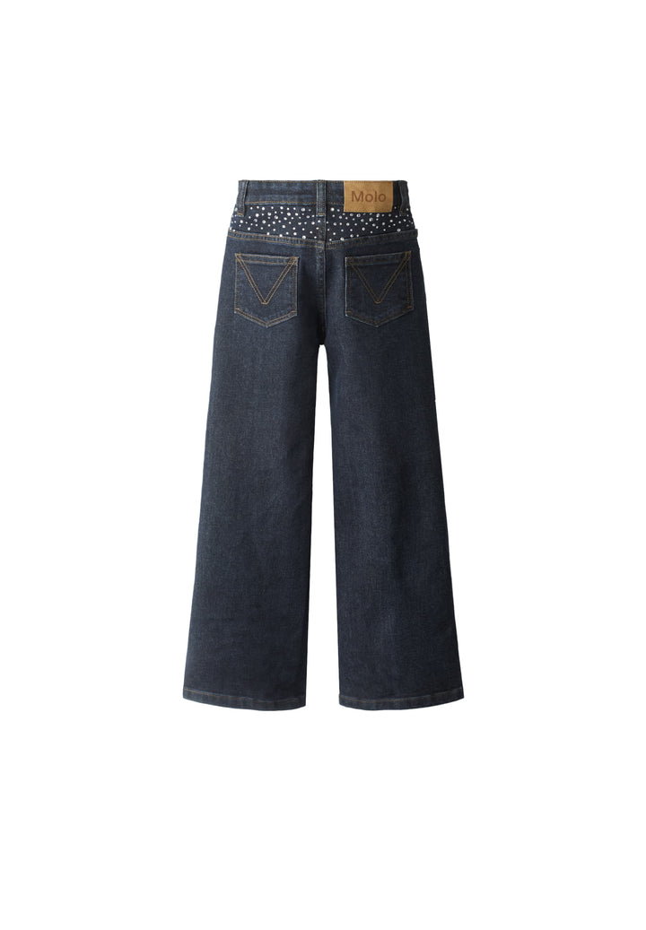 Pair of dark blue jeans with studded details on a white background