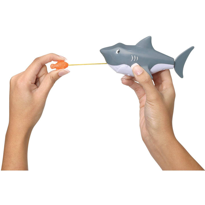 this picture shows how you pull the orange fish and it is attached to a string that the shark can chase. 