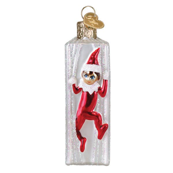 Christmas ornament of an elf in a clear glass bottle on a white background