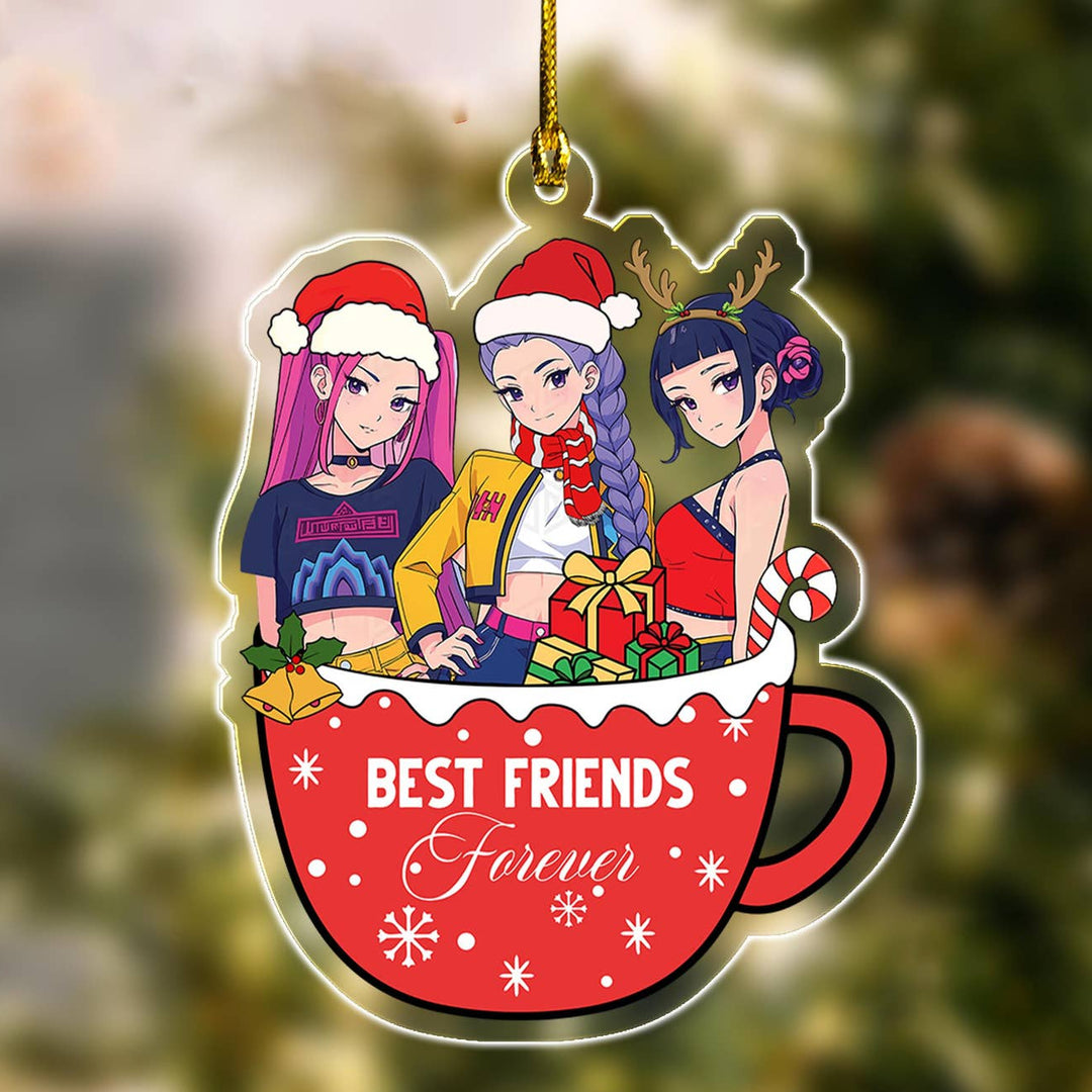 Christmas-themed ornament with three animated characters in a mug, labeled 'Best Friends Forever', against a blurred green background.