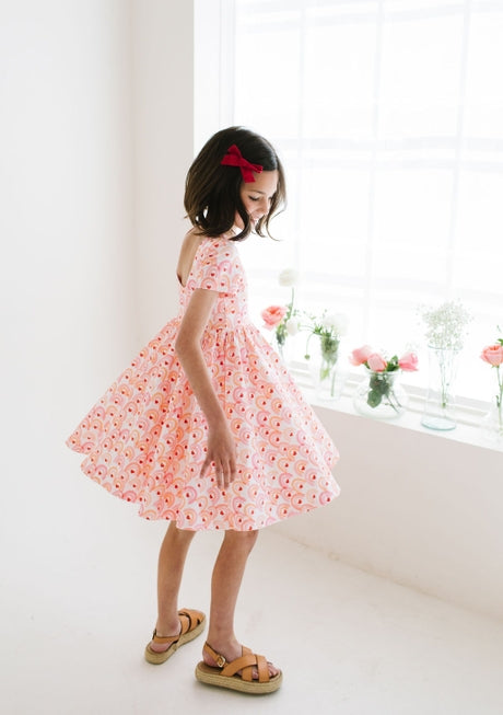 this picture shows a little girl twirling in the full skirt bottom dress. 