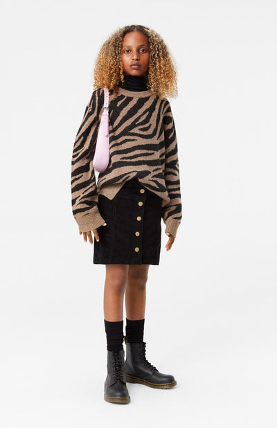 Girl wearing Molo's Gerda Zebra Print Sweater with Bera Mini Corduroy Black Skirt.