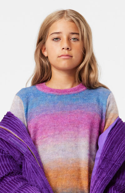 Girl wearing Gemina Rainbow Stripe Round Neck Sweater from Molo. 