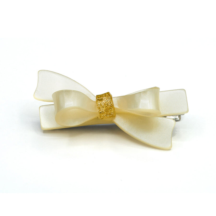 Bow-shaped hair accessory with gold center on a white background