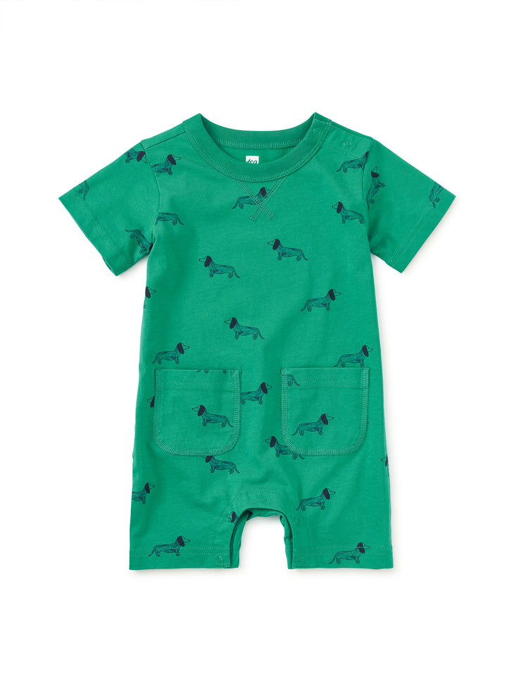 Green romper with dog pattern on a white background