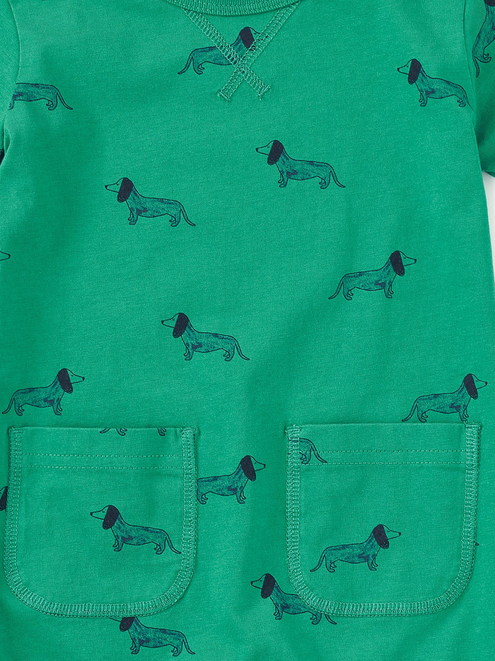 Green romper with dog pattern on a white background