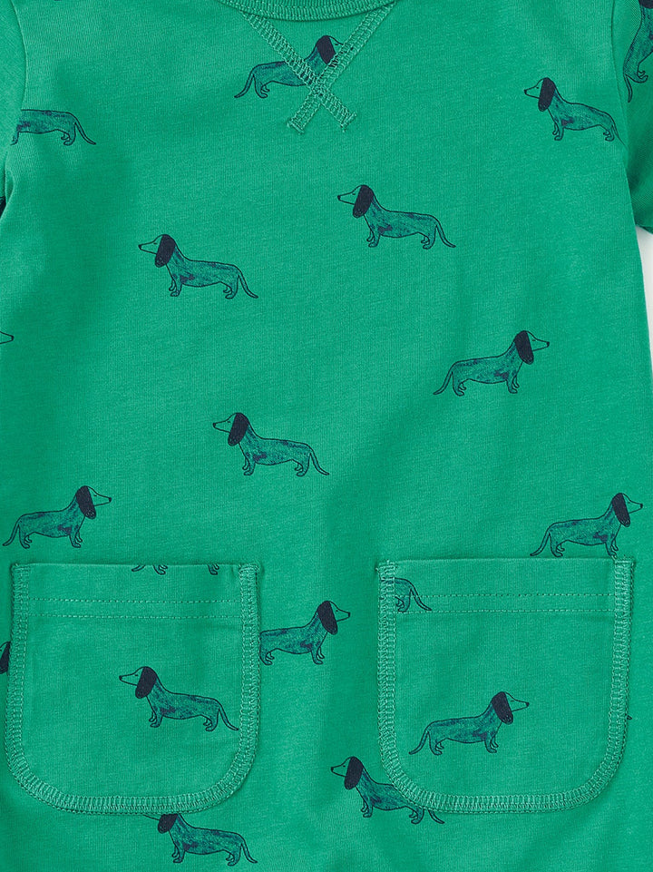 Green romper with dog pattern on a white background