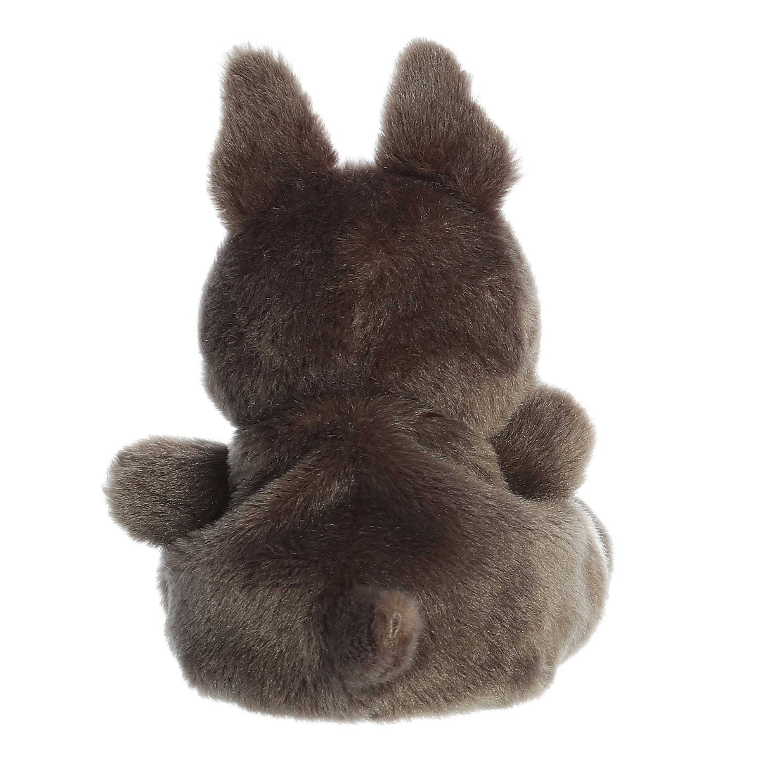 Plush toy resembling back of a puppy on a white background