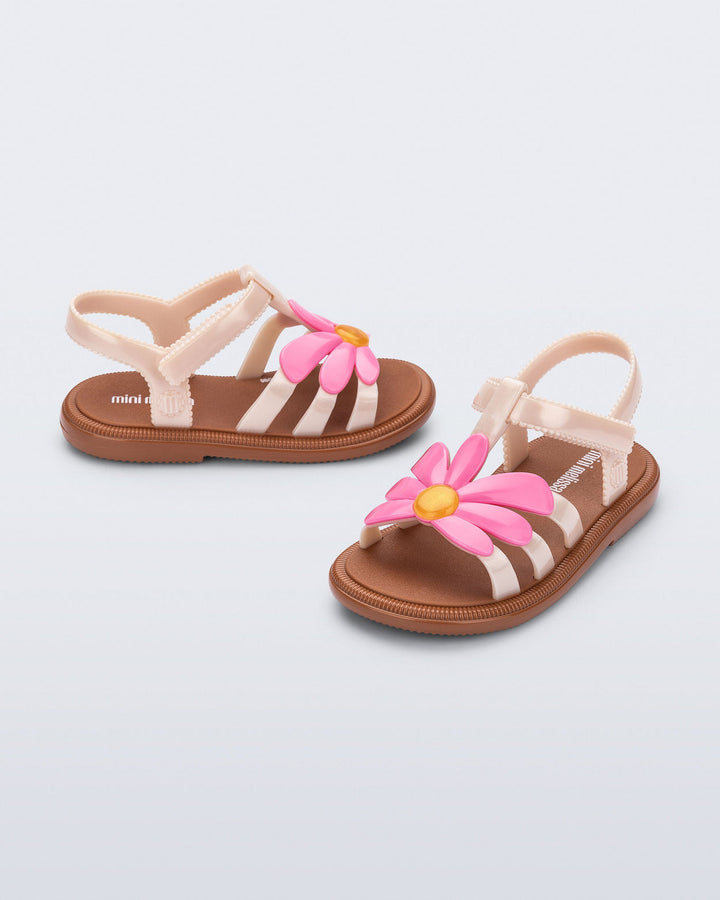 Pair of children's sandals with floral design on a light gray background