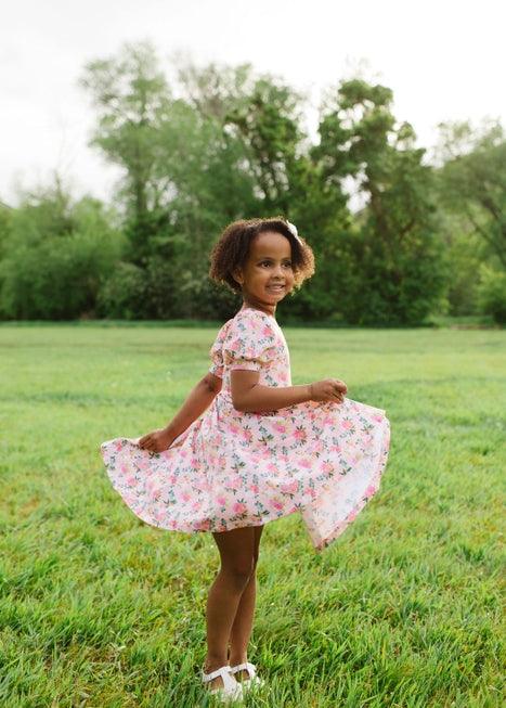 little girls modeling the peach bouquet dress and playing with the full skirt. full twirl potential