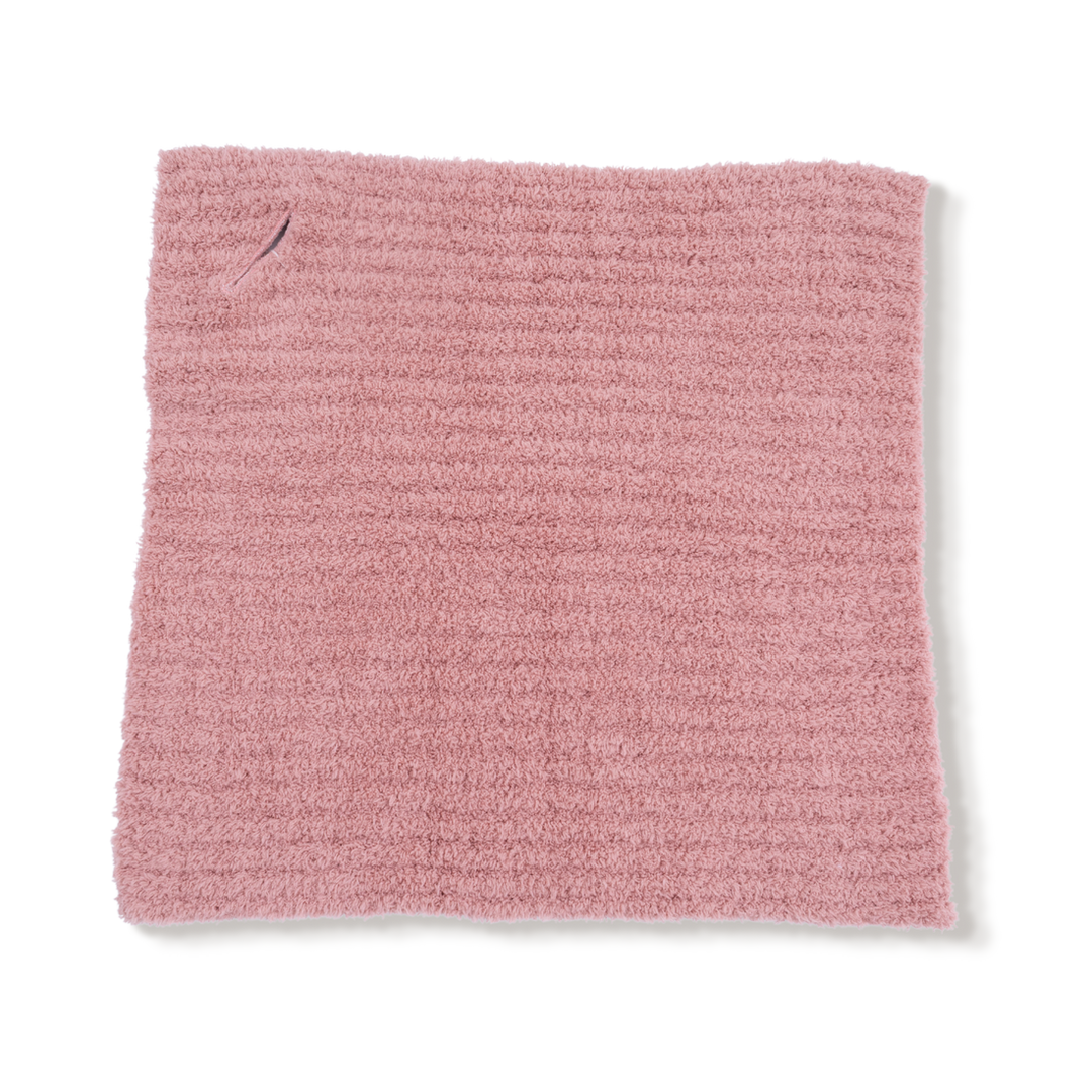 Pink textured fabric square on a white background