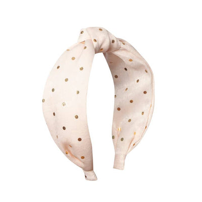 light pink knotted headband with tiny gold dots all over 