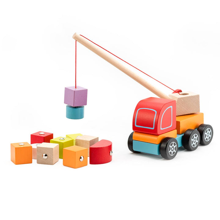 Wooden toy truck with crane lifting colorful blocks on a white background