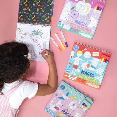 little girl coloring in these magical coloring pads. 