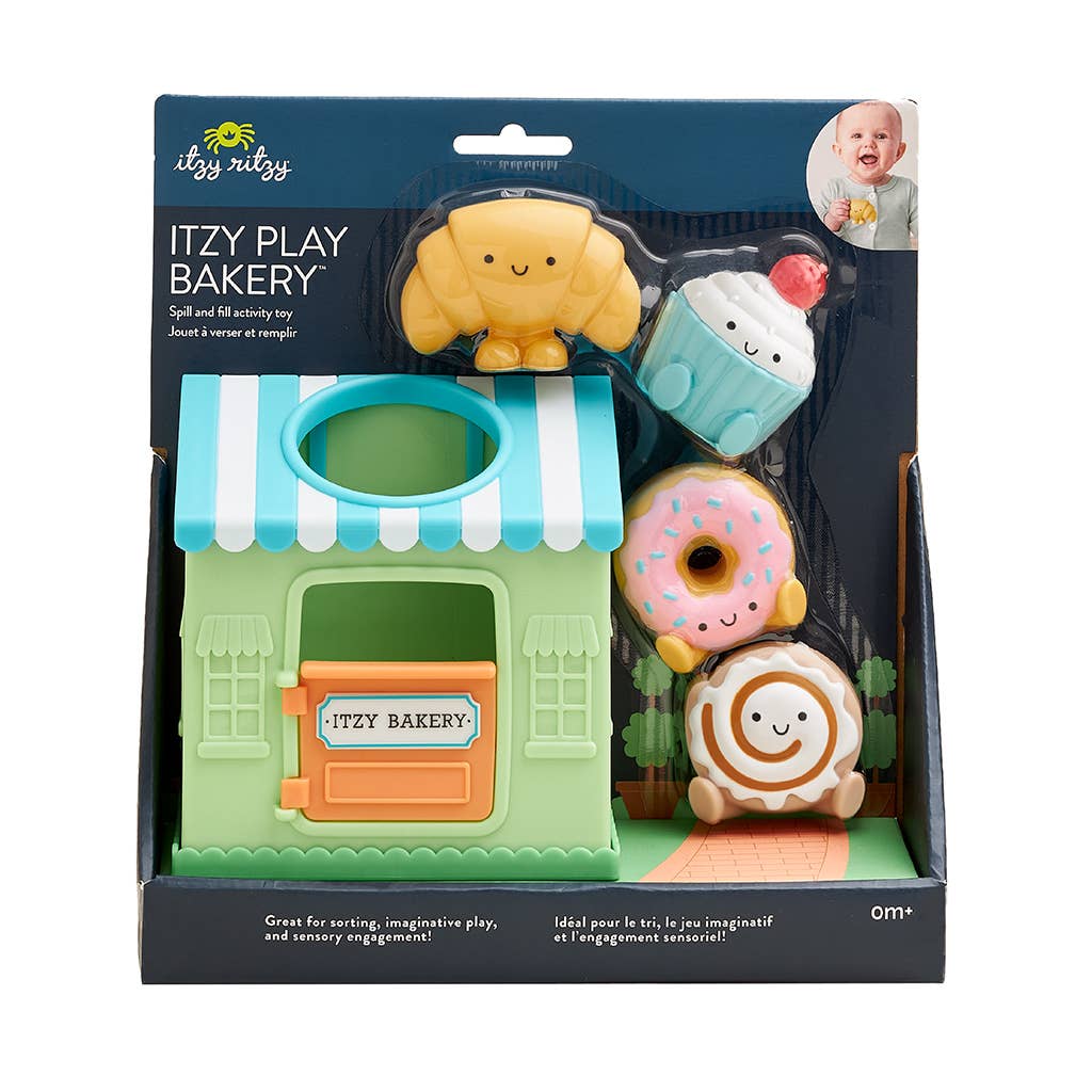 Itzy Play Bakery toy set packaging with a green bakery building and colorful cookies.