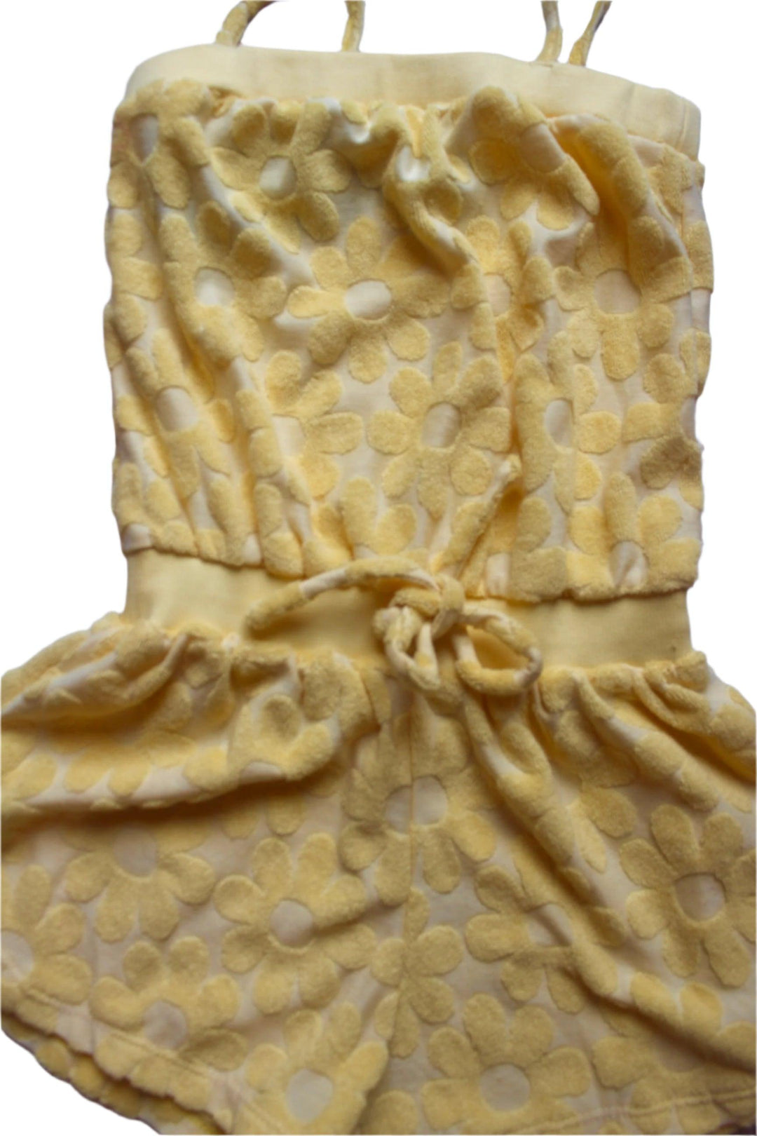 yellow terry cloth romper with daisy embellishments, tie at the waist and spaghetti straps and shorts 