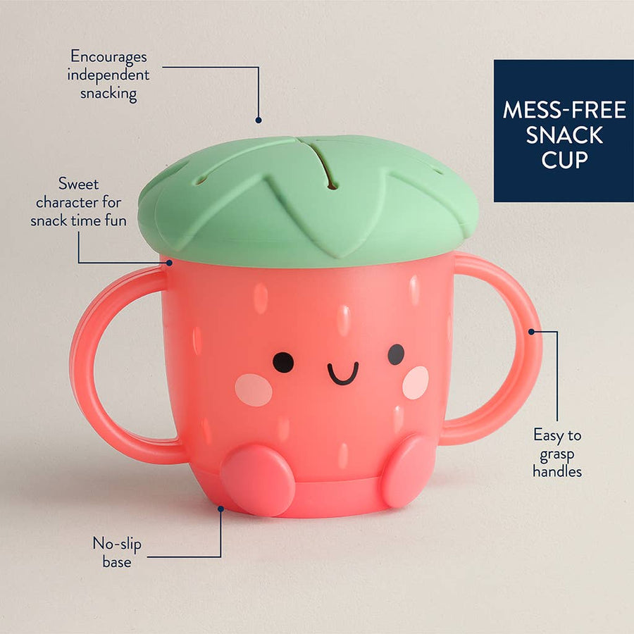 Pink snack cup with green lid on a beige background, featuring text on its features.