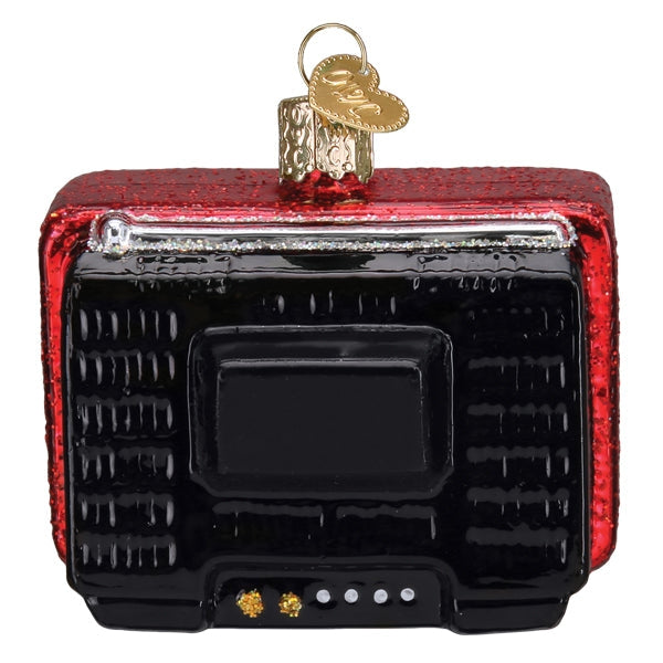 Decorative Christmas ornament shaped like a vintage radio with red and black design.