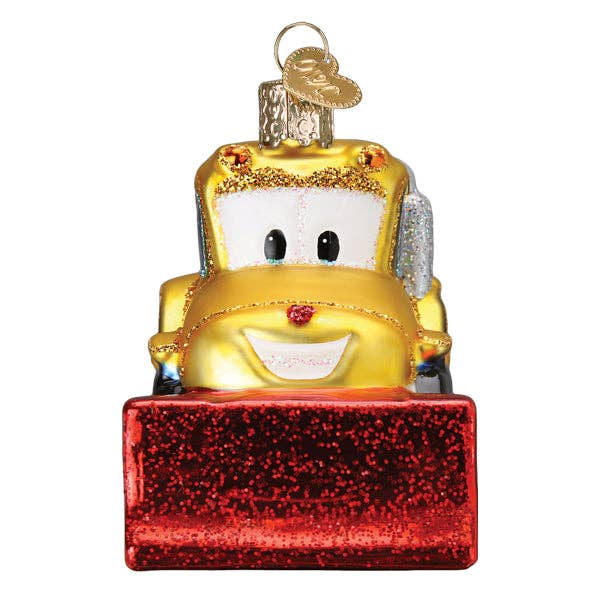 Glass ornament shaped like a yellow truck with a red bumper on a white background