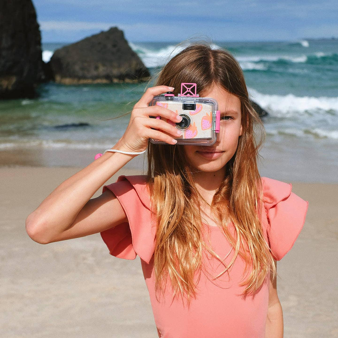 girl posing with the underwater camera at the beach
