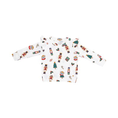 white ruffle sweatshirt with holiday cookies all over. holiday cookies are Nutcracker theme