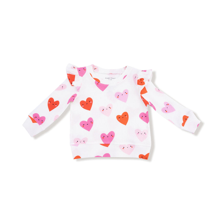 Children's sweater with heart pattern on a white background
