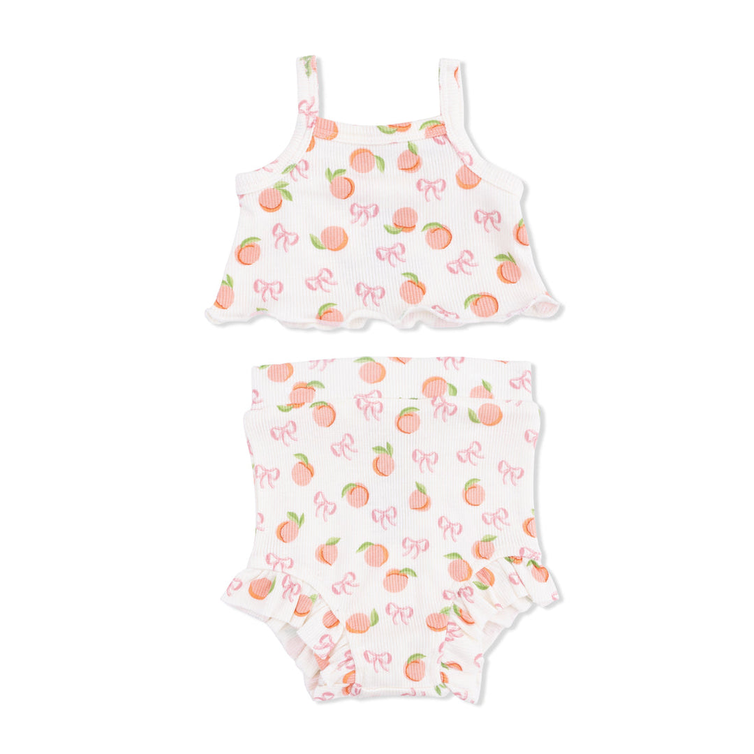 Two-piece baby girl set with Little Peaches and bow pattern on a white background