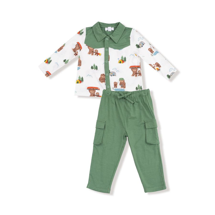 Children's outfit with patterned shirt and green pants on a white background