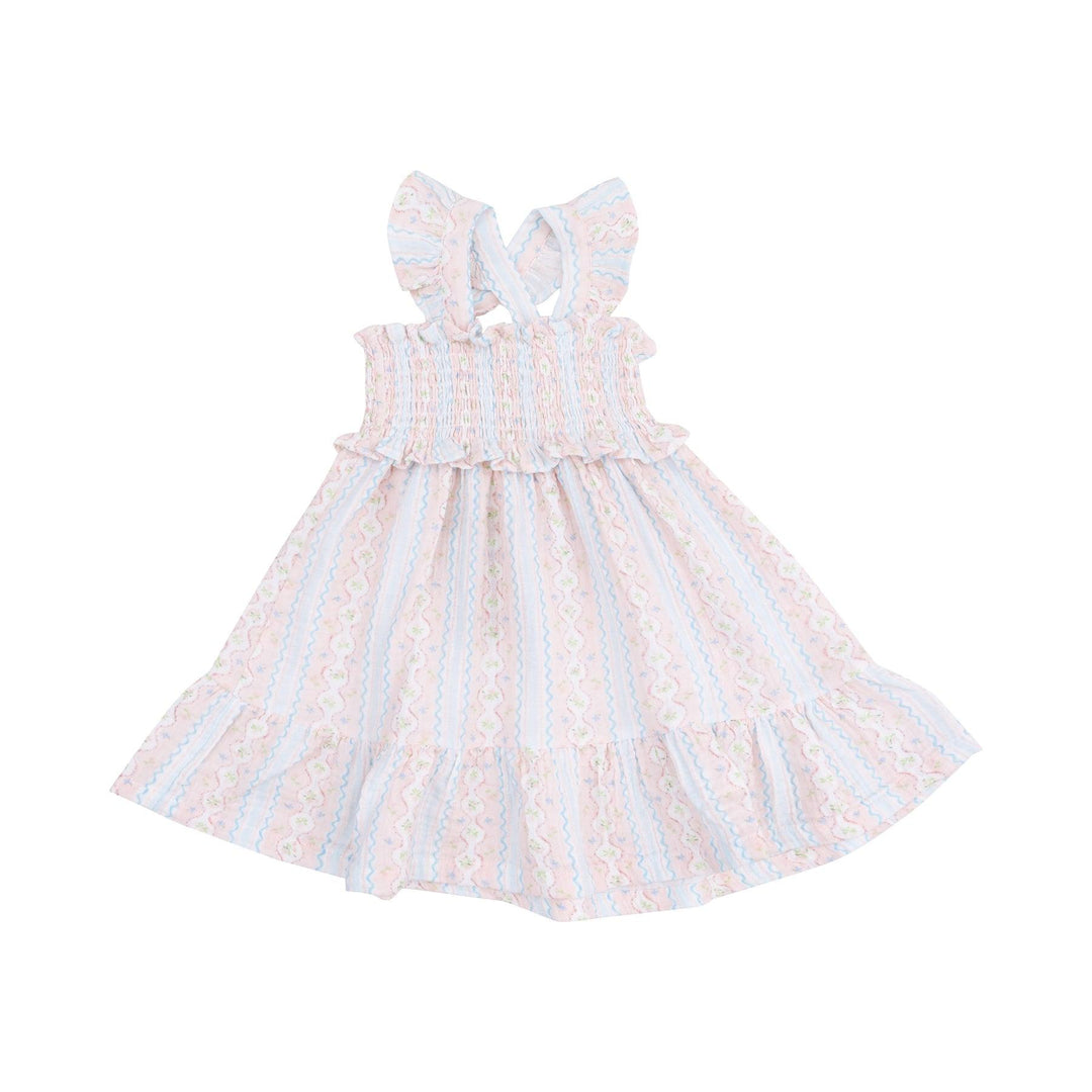 smocked dress with ruffle at the bottom of the dress. pink and blue stripe with the pink stripe being a floral. cross back straps 