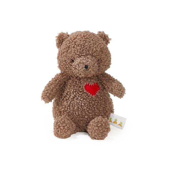 brown teddy bear with red heart patch on his chest. 