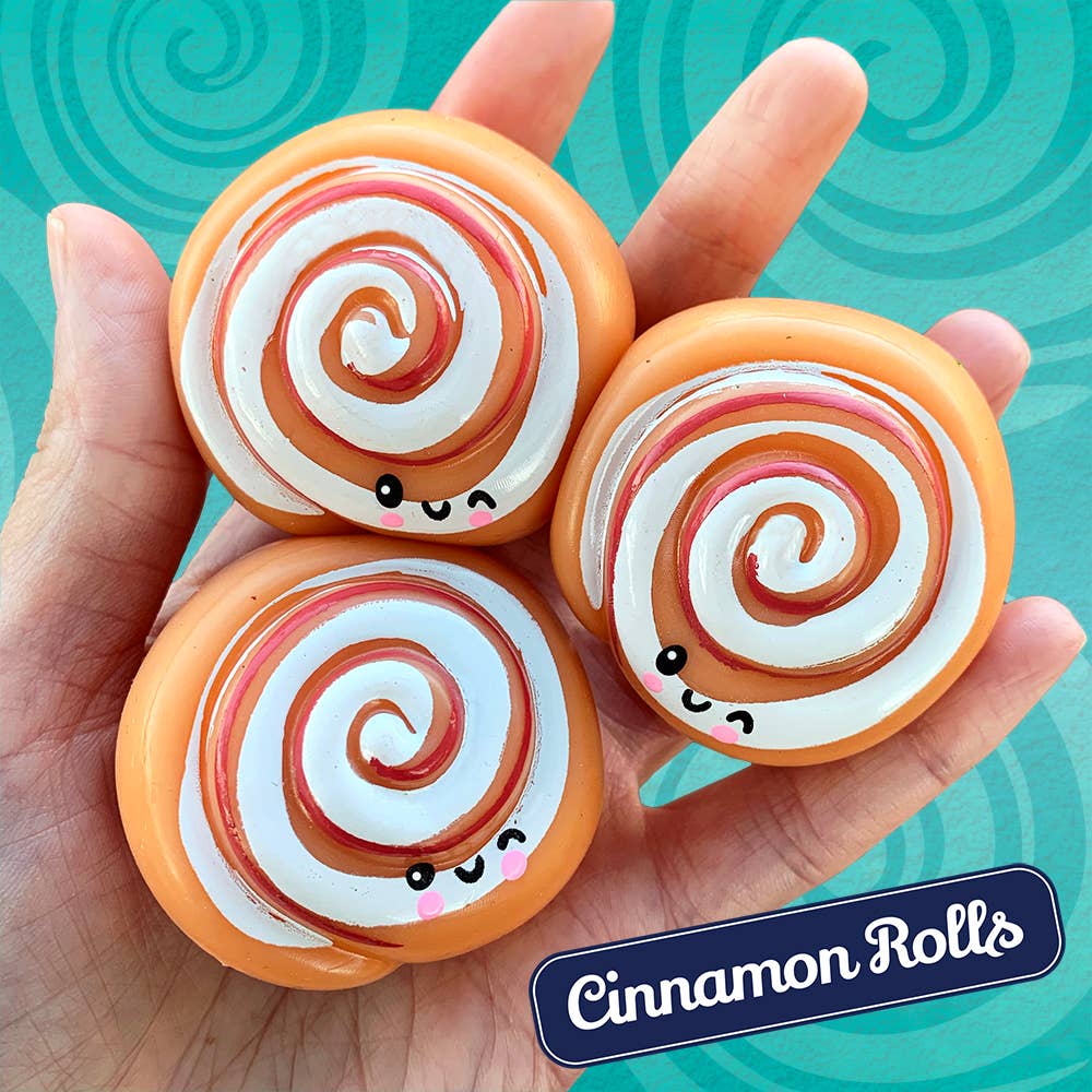 Three cinnamon roll-shaped candies held in a hand with a blue swirling background and 'Cinnamon Rolls' text.