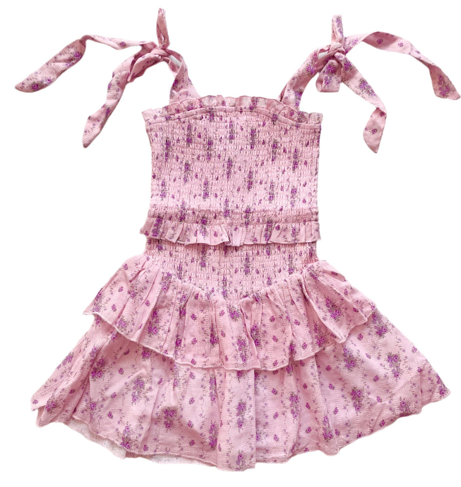smocked dress with lavender floral stripes and straps that tie at the shoulder. dress is more of a lavender pink with purple flowers