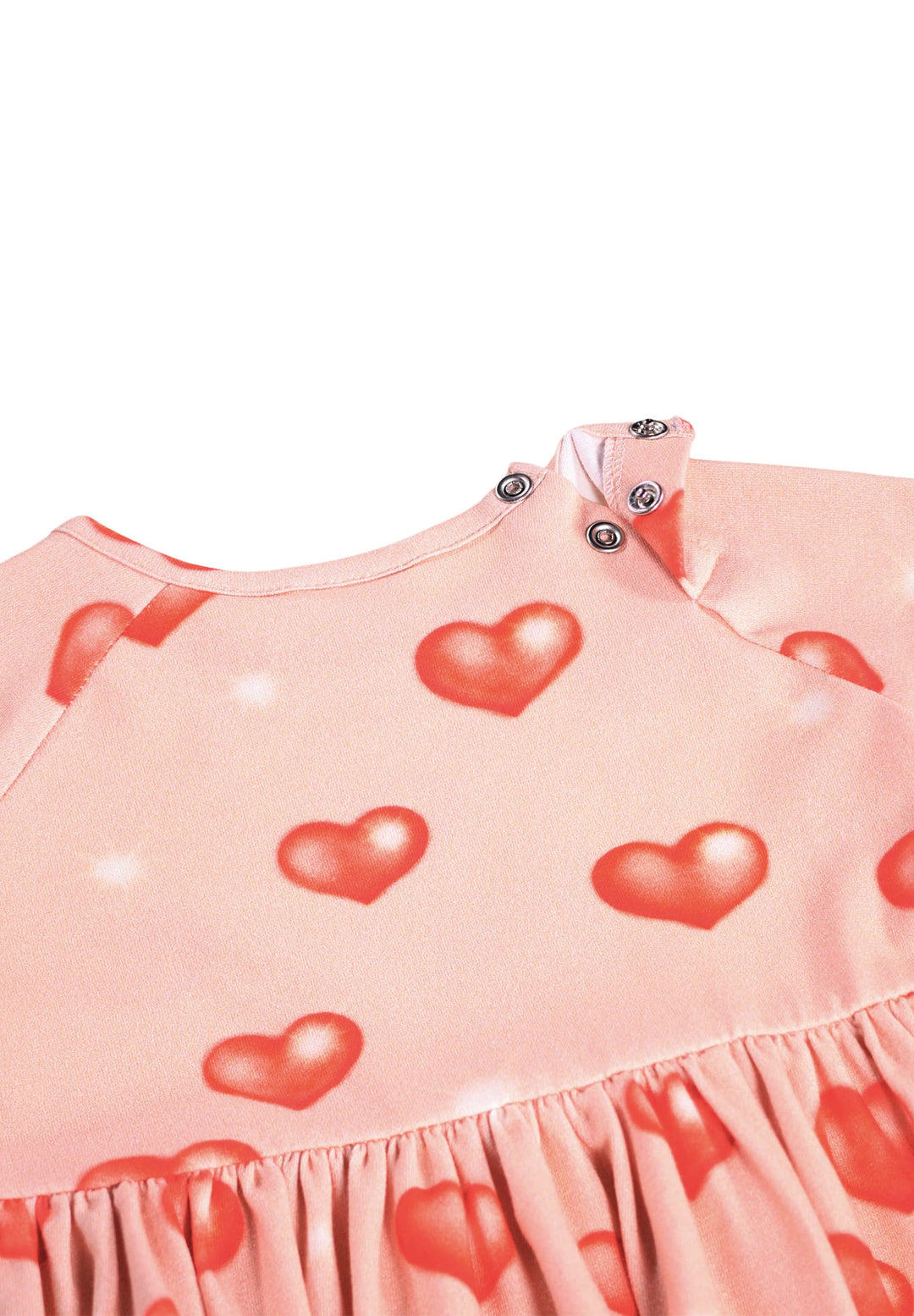 Pink dress with red heart patterns on a white background